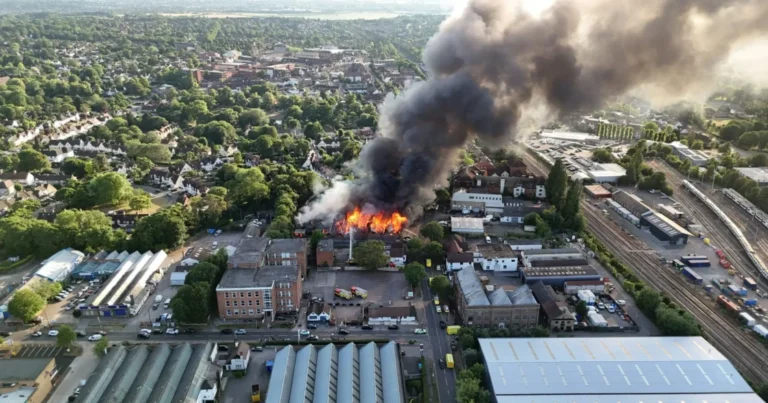 Vue a&eacute;rienne d'un incendie sur un site industriel proche d'habitations, illustrant un accident &agrave; d&eacute;clarer &agrave; l'inspection des installations class&eacute;es